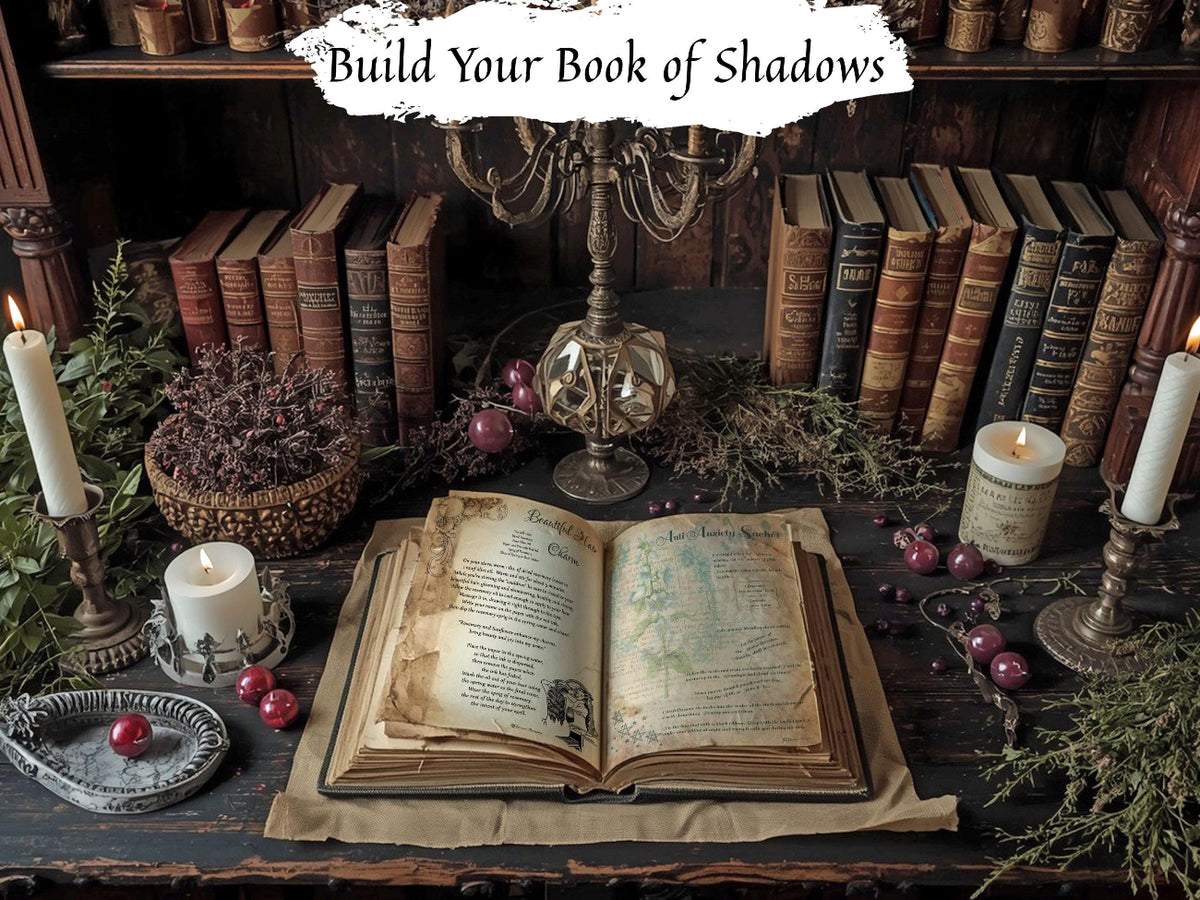 An open antique-style book laid on a dark wooden table, surrounded by candles, old books, greenery, and a glass orb, with the text 'Build Your Book of Shadows' at the top.