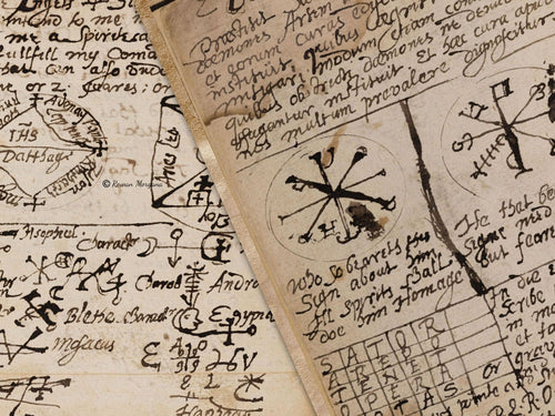 Closeup of Witchcraft parchment pages showing the arcane medieval  handwriting and illustrations.