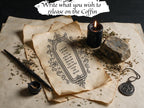 Printable coffin-shaped release worksheet with an ornate border, beside a black candle and herbs. Text reads: Write what you wish to release on the coffin.