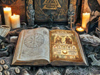 Open book with magical symbols and illustrations  about Freya, placed in a mystical altar setting with candles and figurines.