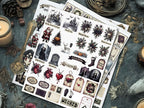 Four sheets of gothic-themed stickers arranged on a dark, rustic tabletop with candles, dried flowers, and vintage props. The stickers feature illustrations of a haunted castle, Santa Claus, a skeleton, anatomical hearts, tombstones, and spooky floral designs in black, white, and muted red and orange tones.