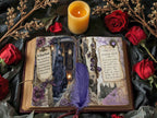 Open gothic-style vintage journal spread with spellbook-inspired pages, surrounded by red roses, dried flowers, and a lit candle for a moody Victorian look.