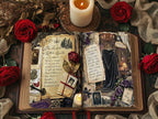 Open gothic-style vintage journal spread with spellbook-inspired pages, surrounded by red roses, dried flowers, and a lit candle for a moody Victorian look.