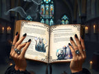 Open book titled 'A Guide to Magical Manifestation' held by hands with dark nail polish and rings, against a mystical background.