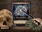 A fantasy tabletop scene showing a printed page titled 'Gods of the Necronomicon: Yog-Sothoth' with a pointer wand, placed on a dark wooden surface beside a skull, dried moss, and a branch. A human hand is holding the pointer.