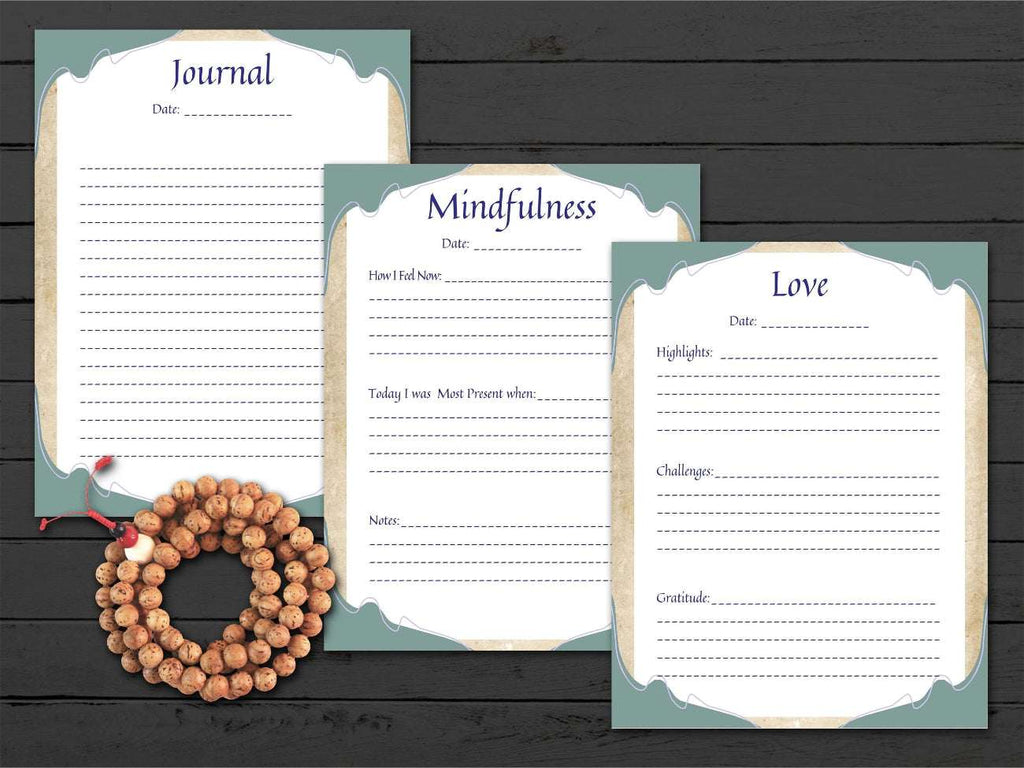 Three journal pages titled 'Journal', 'Mindfulness', and 'Love' on a wooden surface with a rosary.
