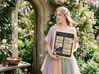 Woman holding a spell parchment paper  in a garden setting