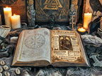 Open book of shadows with magical symbols and illustrations about the Viking God Tyr, on a mystical Norse altar. 