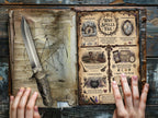 Open book of shadows with magical illustrations and text about why spells fail, with an athame on a wooden surface