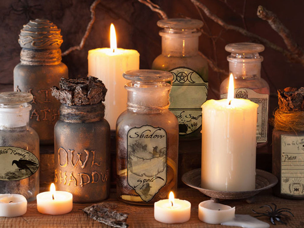 Spooky arrangement with candles and labeled bottles on a dark background