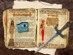 Two pages with images and text about the Goddess Hathor placed in a worn book of shadows.