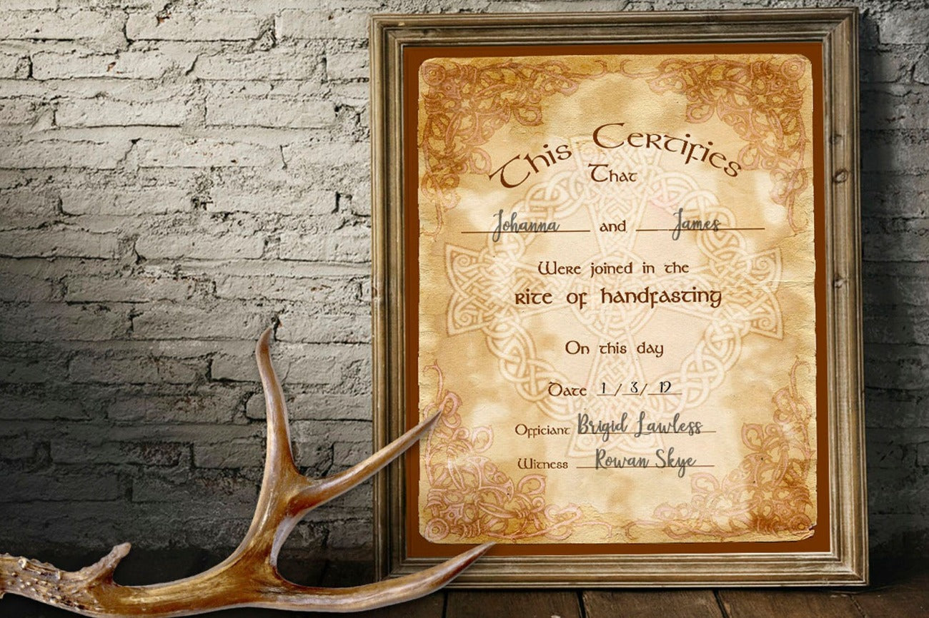 Celtic Handfasting Certificate placed in a rustic wooden frame with an antler placed beside it.