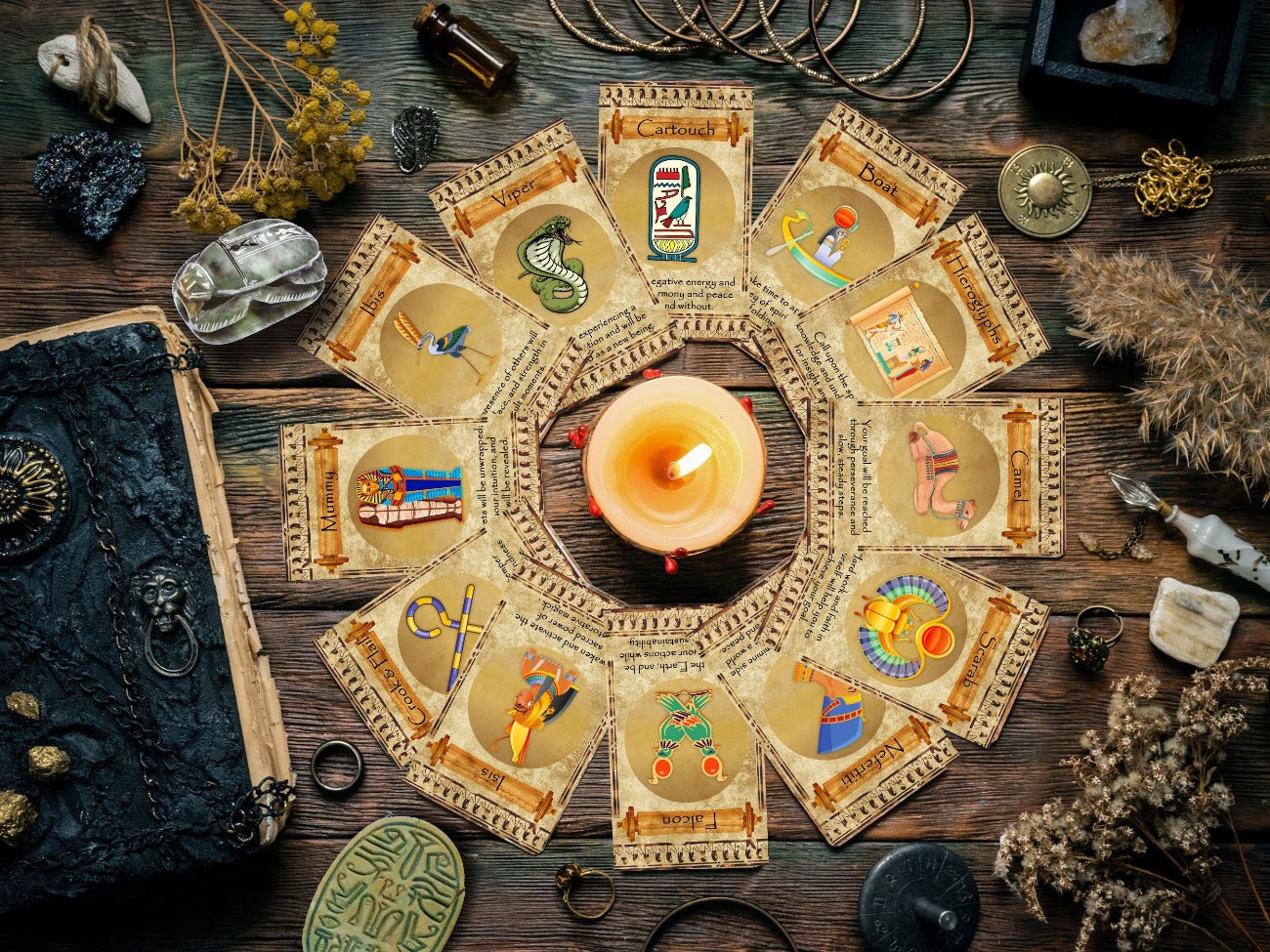 Egyptian Oracle cards are placed in a circle around a lit candle on a wooden altar.