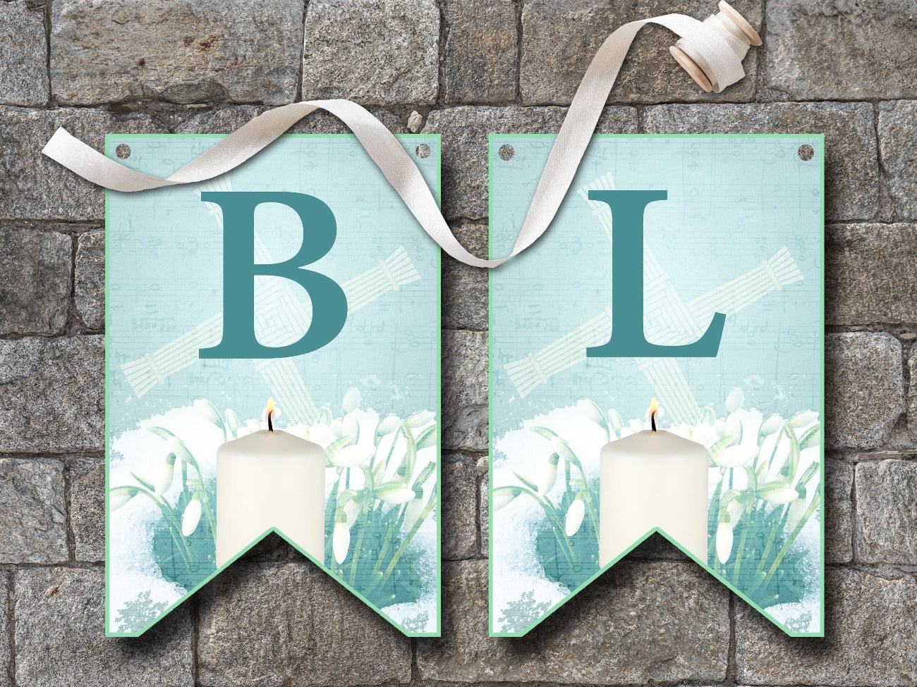 IMBOLC BANNER Bunting, Flags B and L, flags are pale blue with dark blue letters, each flag is imbellished with a Brigids Cross, snowdrops peeking through a layer of snow and a lit white candle - Morgana Magick Spell