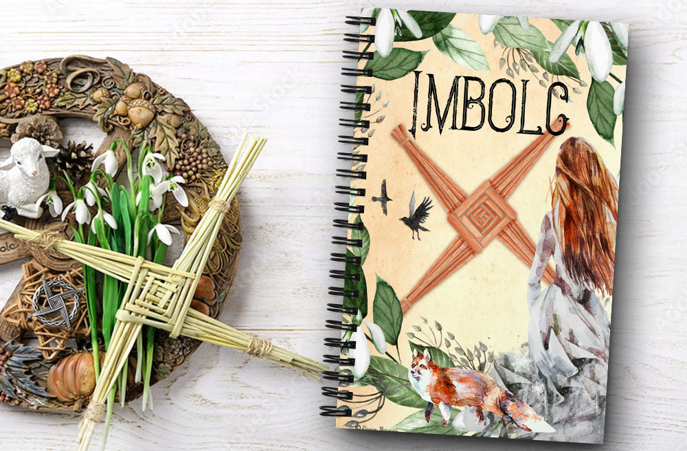 Imbolc Spiral notebook with images of snowdrops, goddess brigid, a fox and a brigid's cross.
